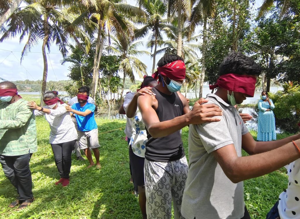 inclusion-breaking dawn barriers. Youth wearing blindfolds and playing a game in India